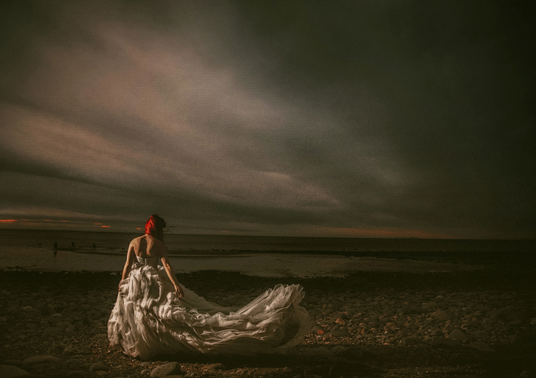 bride on the beach in the wind